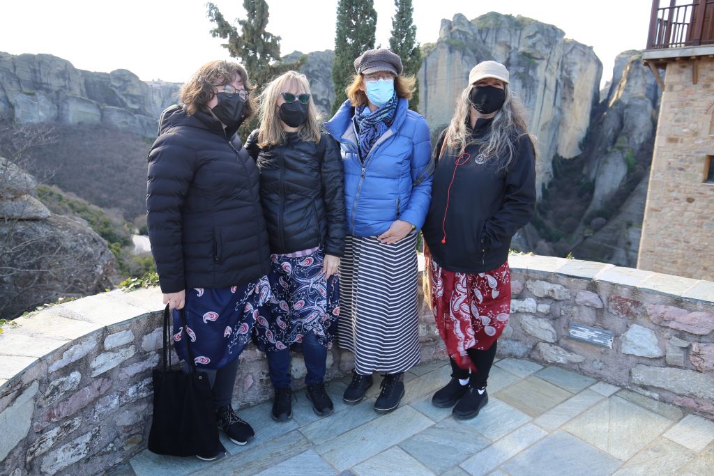 Females in skirt, standing at entrance to Monastery of St Stephens