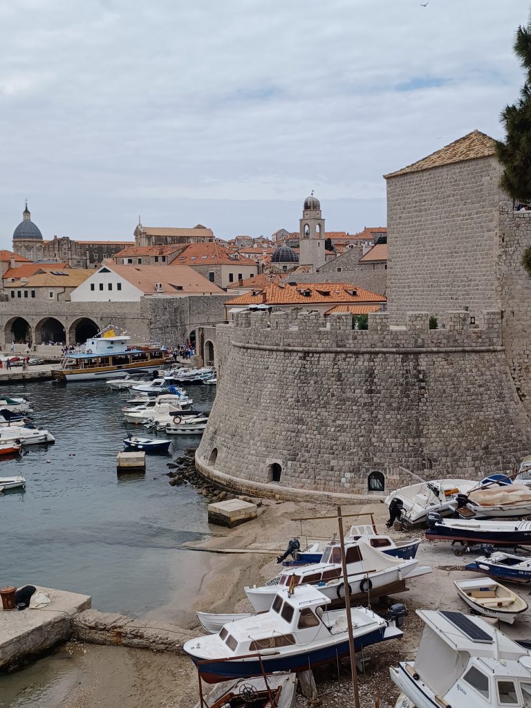 Harbour view with one of Dubrovnik's circular towers plus ferry boat rear left