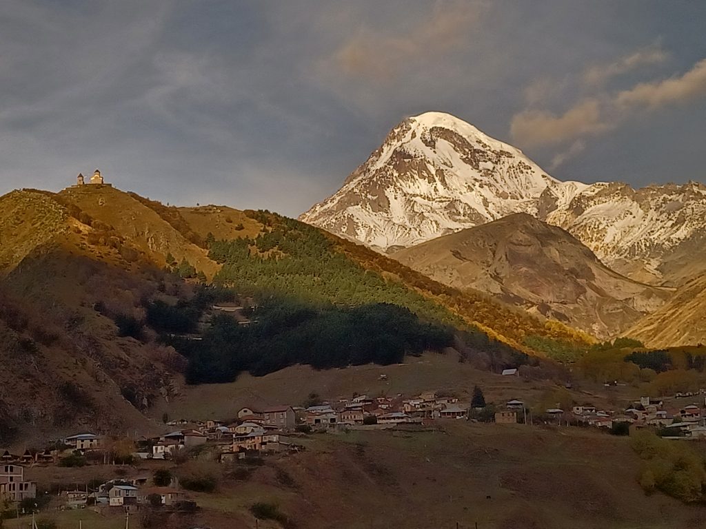 Sunrise over Kazbegi mountain and Gergeti Trinity Church
