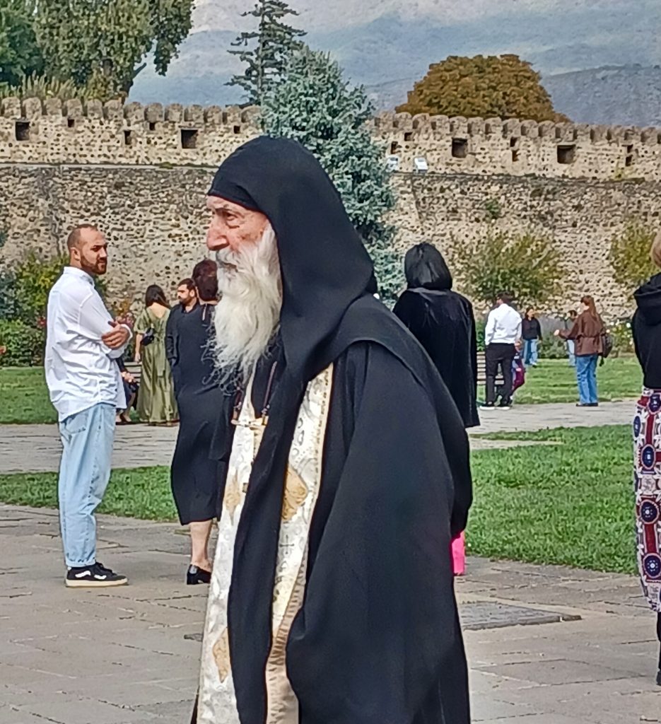Orthodox clergyman, defensive wall behind