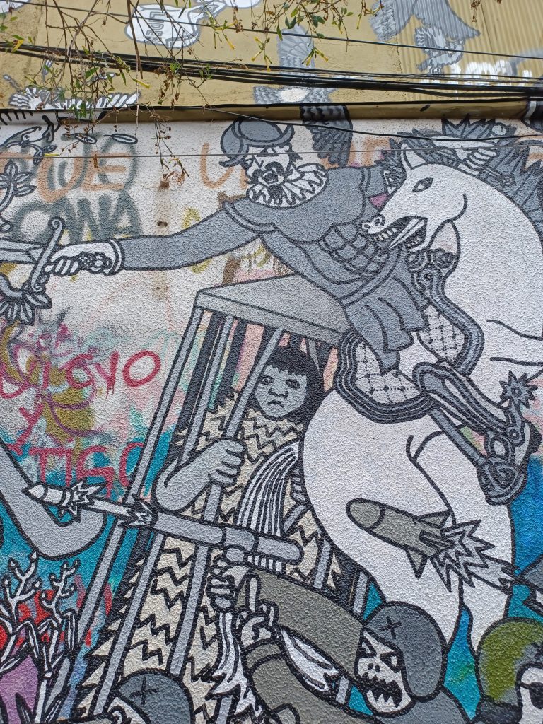 Conquistador on horse attacking the locals and Mapuche man in a cage.