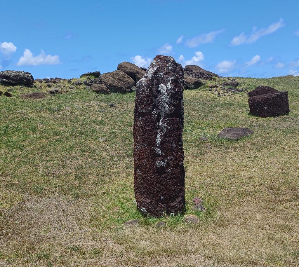 Lone female moai with the two heads removed and toppled moai behind, Vinapu