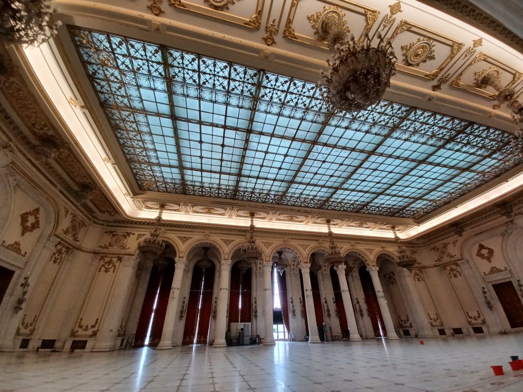 Union Hall with glass skylight and buckets on marble floor.