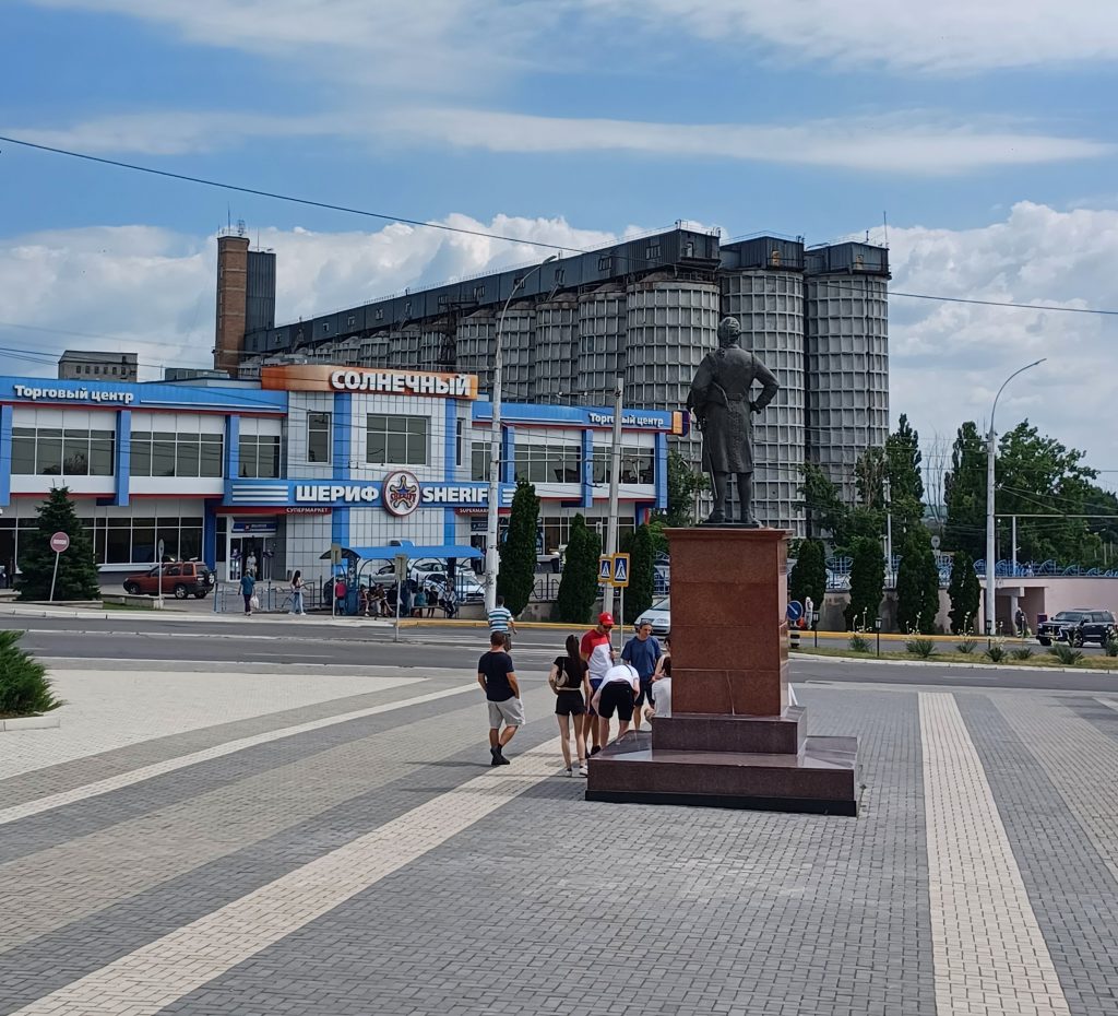 Supermarket and silo and statue in front of Military Cemetery